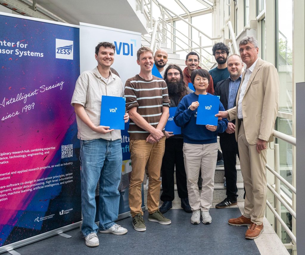 Presentation of Best Poster (P) and Best Lightning Talk (LT) awards. From left to right: Marius Bock (1st LT), ZESS spokesman Prof Kristof Van Laerhoven, Alireza Yazdani (2nd LT), Jannis Maron (3rd P), Mohamed Saleh for Hendrik Sommerhoff (1st P), Qiushuang Zhang (1st P) Muhammad Syed kazim (3rd P), and VDI representatives NN and Prof Dr Jörg Himmel [Photo Jan Söhlke/ZESS, Uni Siegen]