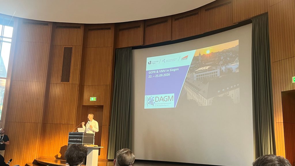 ZESS member Prof Michael Moeller presents the Siegen venue for GCPR/VMV 2026 at this year's GCPR in Freiburg.
